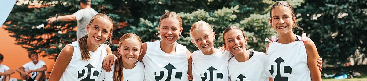 Group of young female soccer players smiling together at a Storm elite residential camp 2
