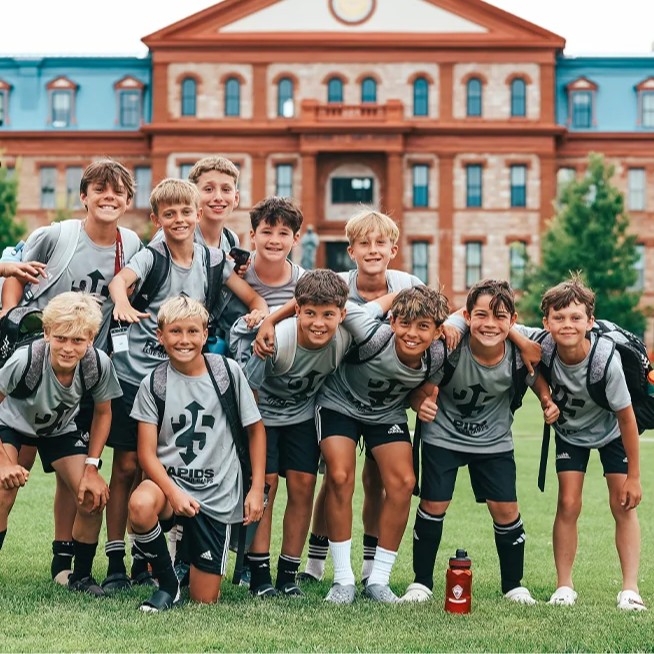 Group of youth soccer players posing together on the Regis University campus for Storm camp