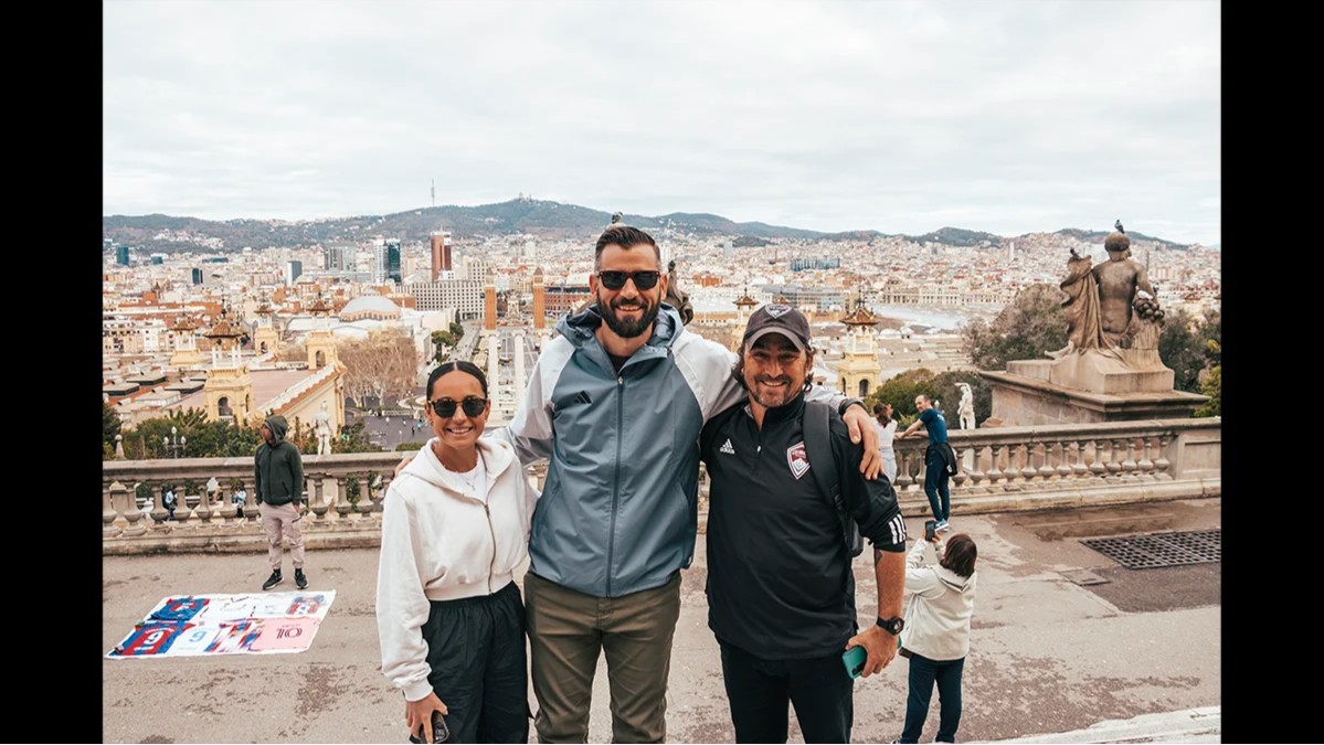 Storm soccer coaches pose for a photo overlooking the city of Barcelona during an international trip