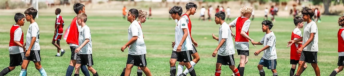 Two rows of youth soccer players shaking hands after a competitive game in Colorado 4