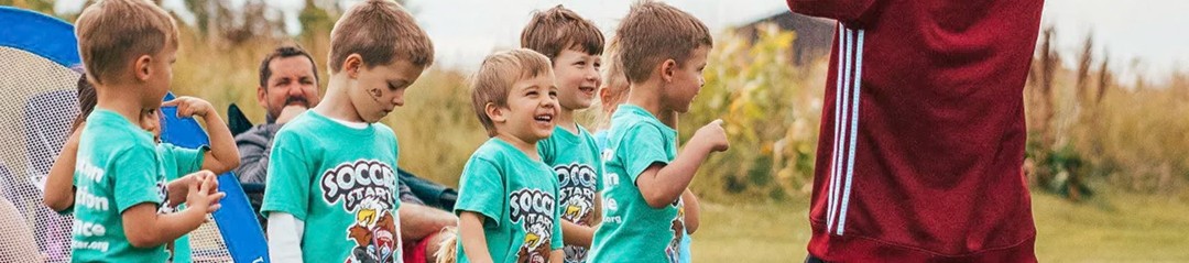 Young soccer players practicing ball control drills with a coach at a Sparks practice in Denver 1