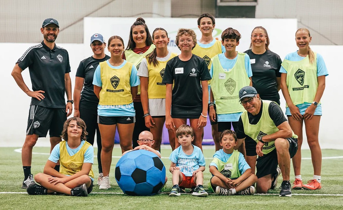 adaptive soccer team and coaches posing together