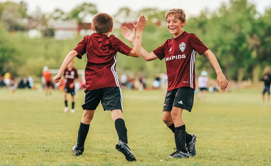 boys soccer players giving a high five