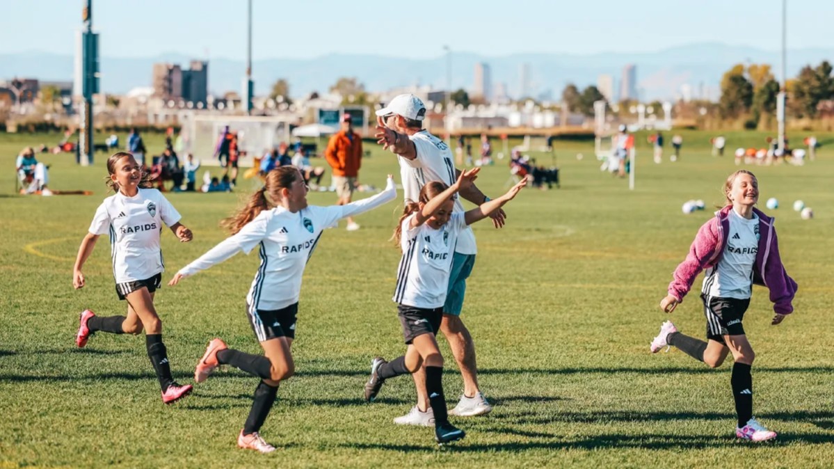 girls soccer players high fiving in colorado