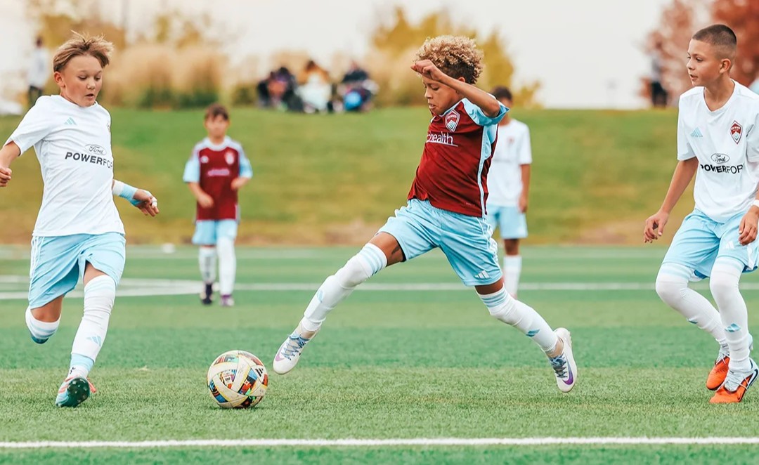 youth soccer competitive player dribbling storm