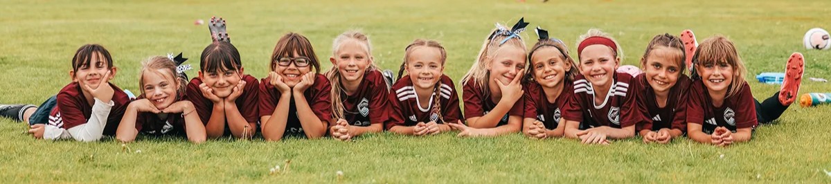 youth soccer team laying in the grass
